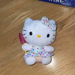 Hello kitty ty stuffed animal holding a sucker. 6.5 inches